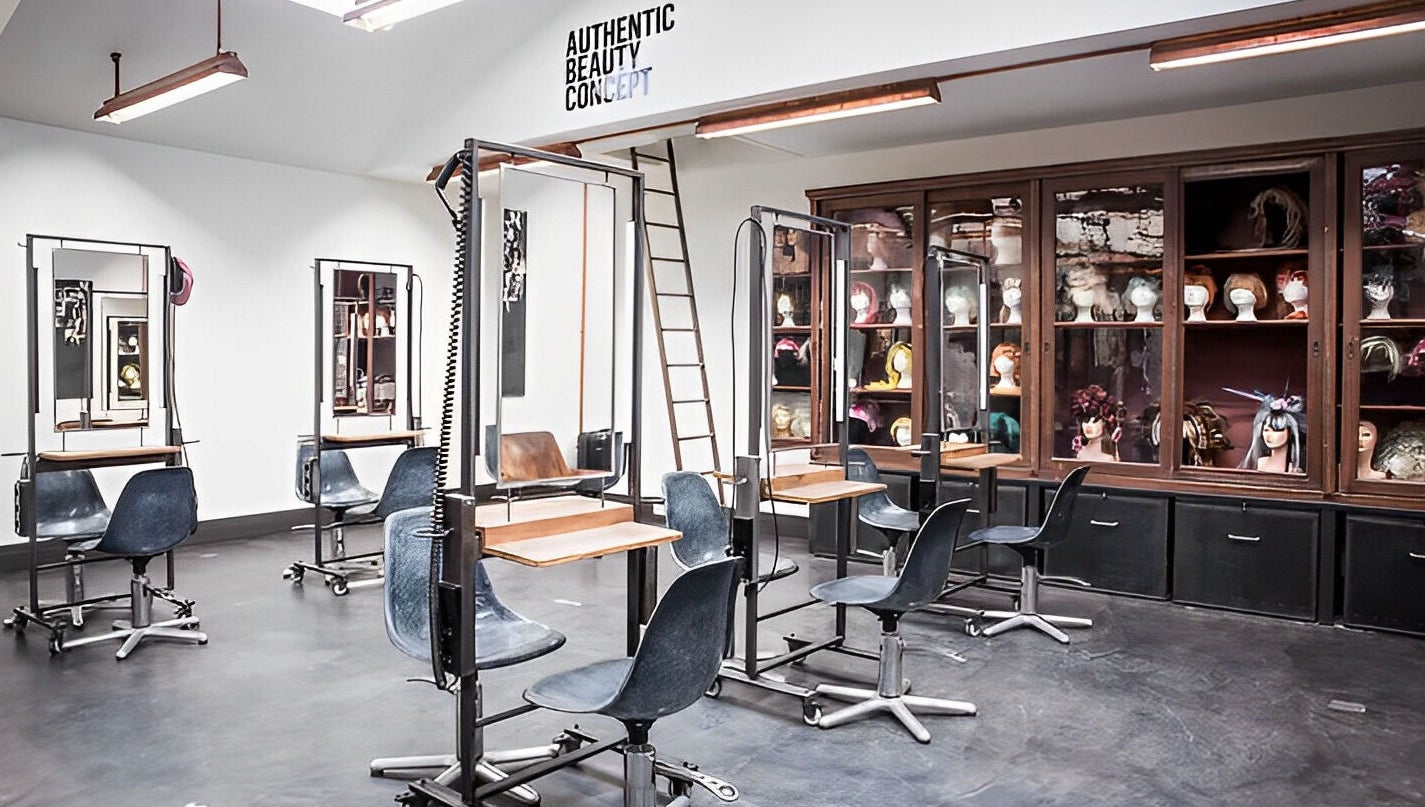 Modern hair salon interior at Mogeen, Amsterdam, Noord-Holland, NL with stylish chairs and mirrors.