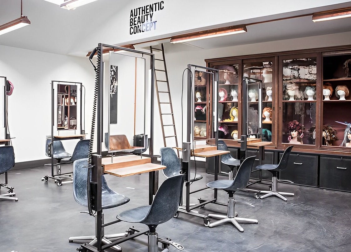 Modern hair salon interior at Mogeen, Amsterdam, Noord-Holland, NL with stylish chairs and mirrors.