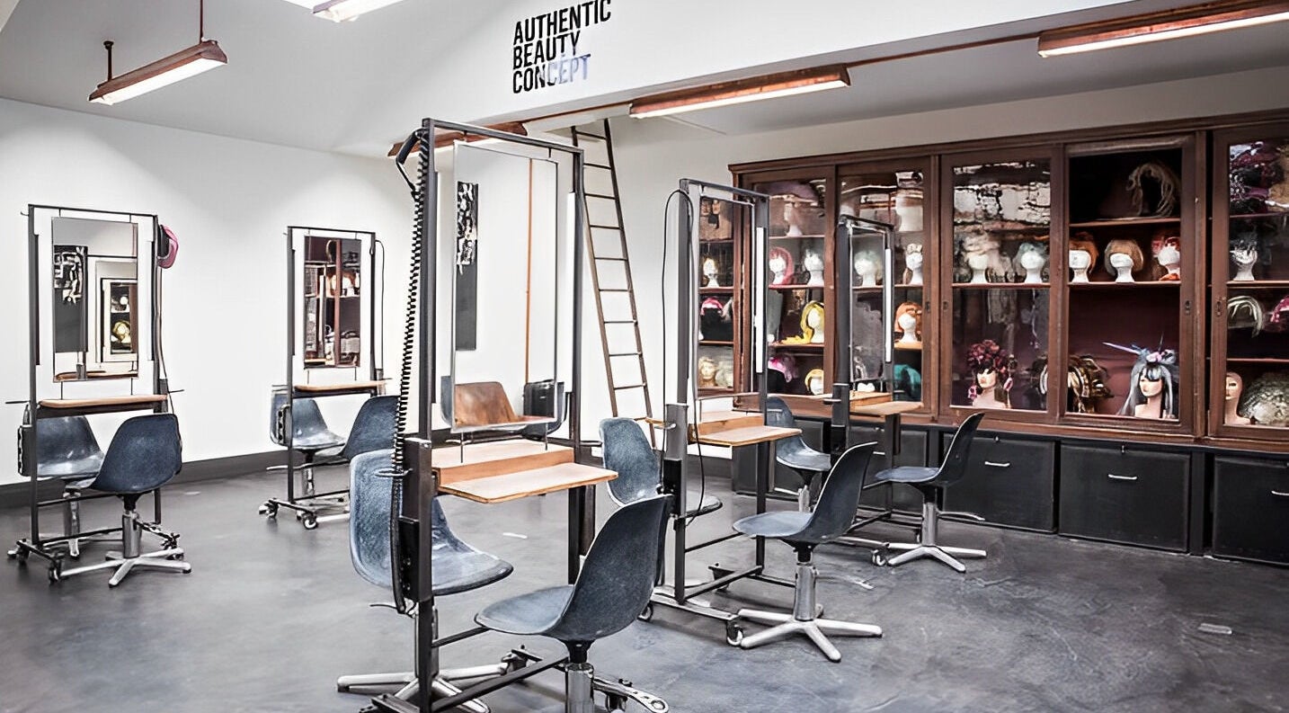 Modern hair salon interior at Mogeen, Amsterdam, Noord-Holland, NL with stylish chairs and mirrors.
