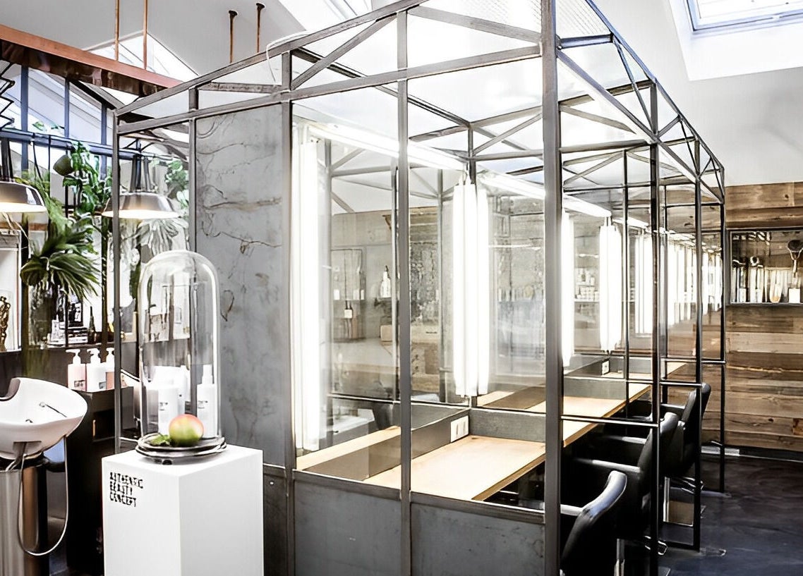 Modern interior of Mogeen salon in Amsterdam, Noord-Holland, NL, showcasing sleek design and beauty stations.