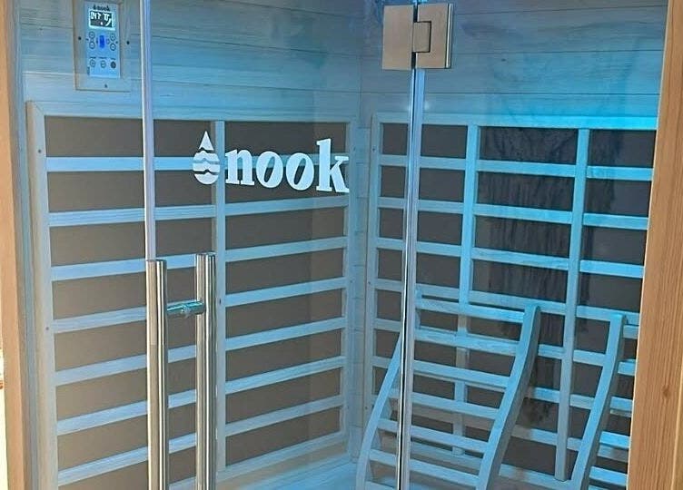 Modern sauna at The Red Sauna Deal in Deal, England, GB with sleek wooden panels and a glass door.