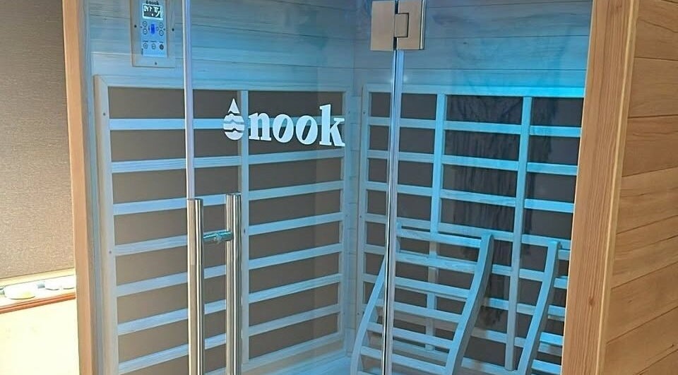 Modern sauna at The Red Sauna Deal in Deal, England, GB with sleek wooden panels and a glass door.