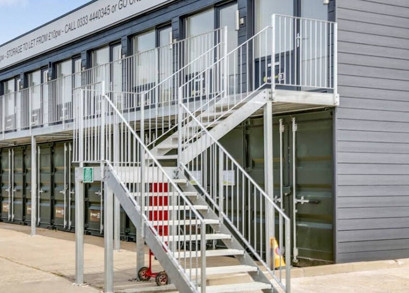 Exterior view of The Red Sauna Deal in Deal, England, GB, featuring modern gray architecture and metal stairs.