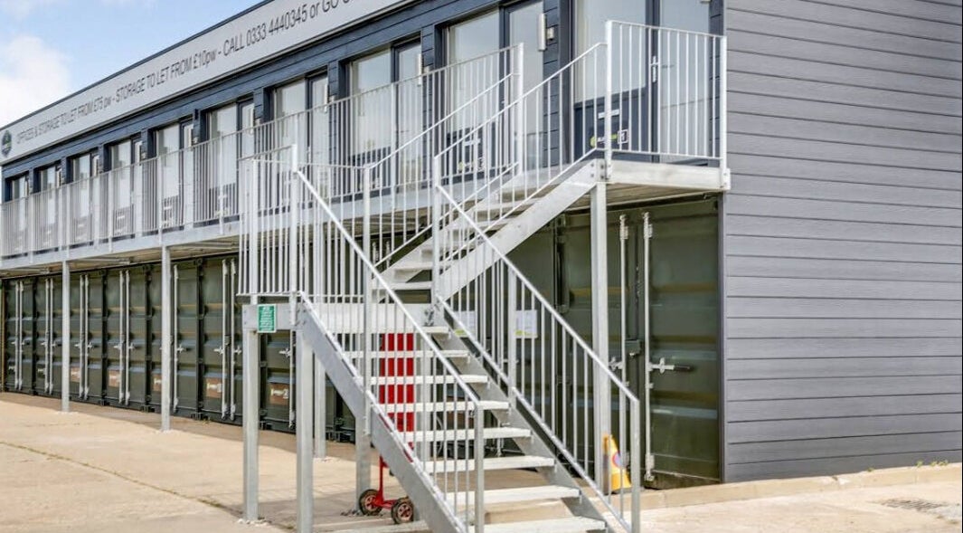 Exterior view of The Red Sauna Deal in Deal, England, GB, featuring modern gray architecture and metal stairs.
