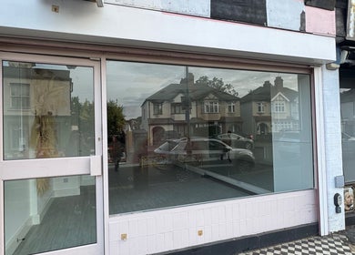 Exterior view of Nova Head Spa in Sutton, England, GB, showcasing its modern glass storefront.