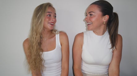 Two women smiling at Nova Head Spa, located in Sutton, England, GB, enjoying a relaxing environment.