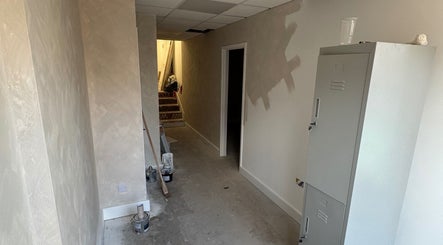 Nova Head Spa under renovation in Sutton, England, GB. Freshly painted hallway and lockers.
