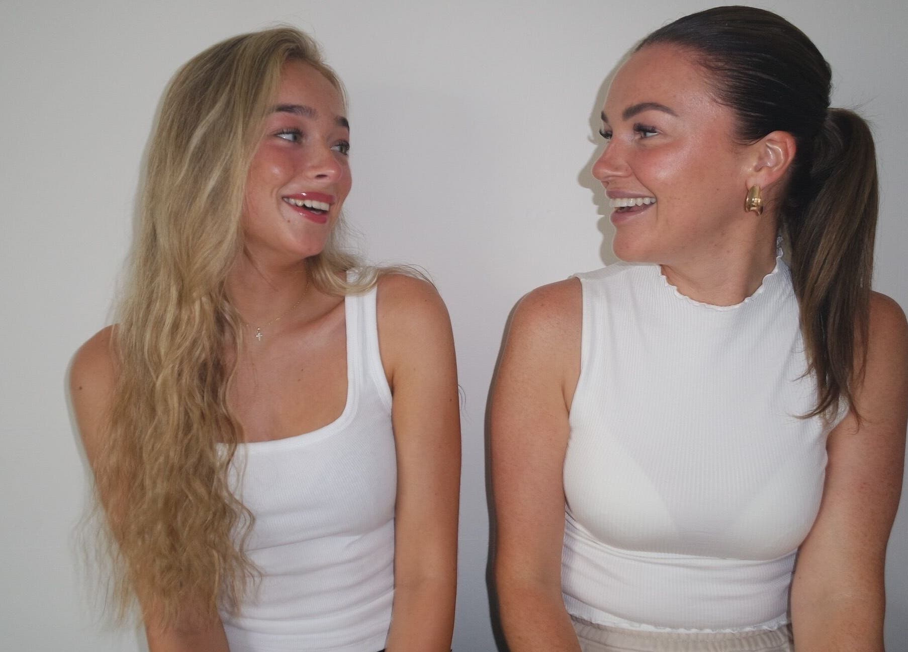 Two smiling women sharing a moment at Nova Head Spa, Sutton, England, GB.