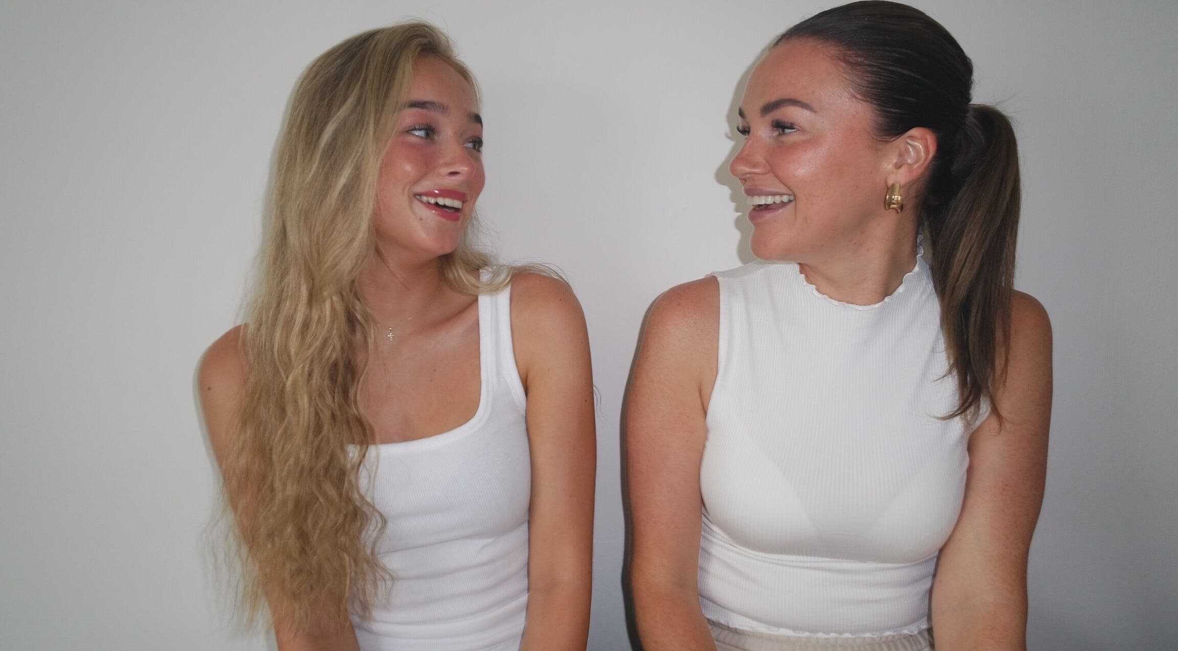 Two smiling women sharing a moment at Nova Head Spa, Sutton, England, GB.