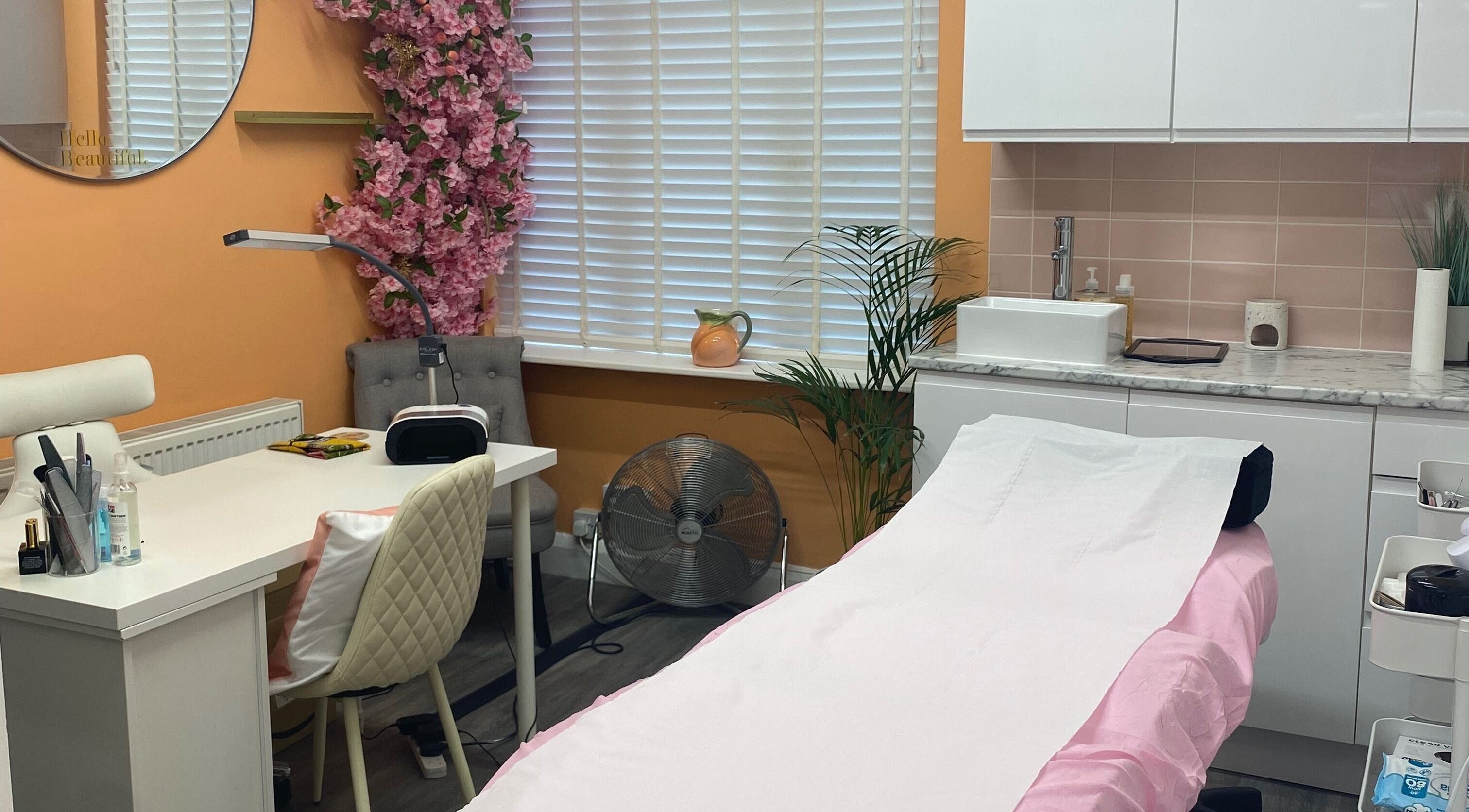 Inside Peaches Beauty Studio, Nottingham, England, GB, showcasing a serene treatment room with pink accents.
