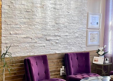 Relaxing lounge at Mantra Thai Massage & Spa in Vienna, Virginia, US with purple chairs and modern decor.