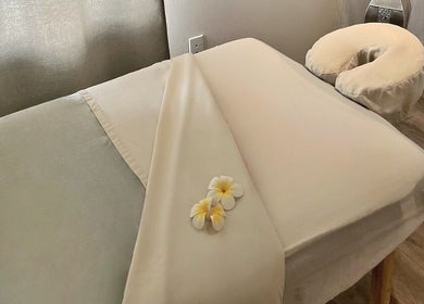 Calming massage table at Mantra Thai Massage & Spa, Vienna, Virginia, US with fresh flowers accentuating relaxation.