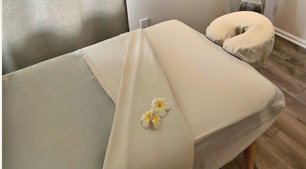 Relaxing massage bed at Mantra Thai Massage & Spa, Vienna, Virginia, US, with soft linens and flowers.