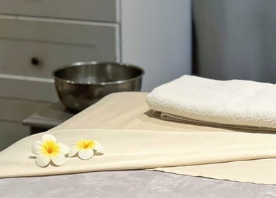 Relaxing massage table setup at Mantra Thai Massage & Spa, Vienna, Virginia, US, with fresh towels and decor.