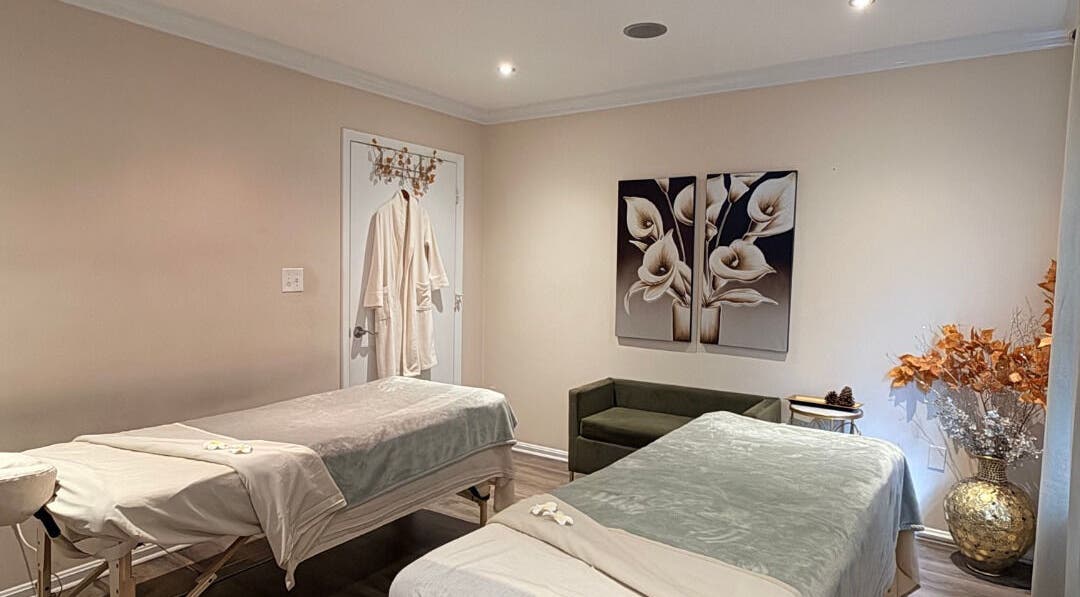 Tranquil massage room at Mantra Thai Massage & Spa in Vienna, Virginia, US, featuring two massage tables.