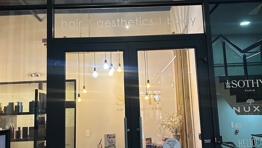 Elegant entrance of Shugarlashpro | Sandton Gate in Sandton, Gauteng, ZA with modern lighting.