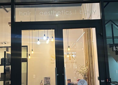 Elegant entrance of Shugarlashpro | Sandton Gate in Sandton, Gauteng, ZA with modern lighting.