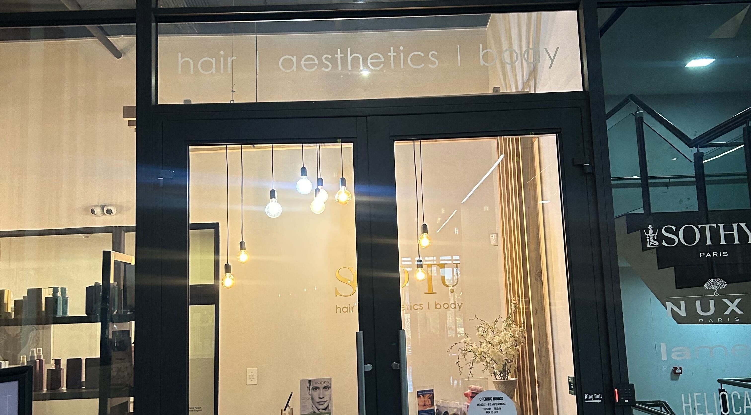 Elegant entrance of Shugarlashpro | Sandton Gate in Sandton, Gauteng, ZA with modern lighting.