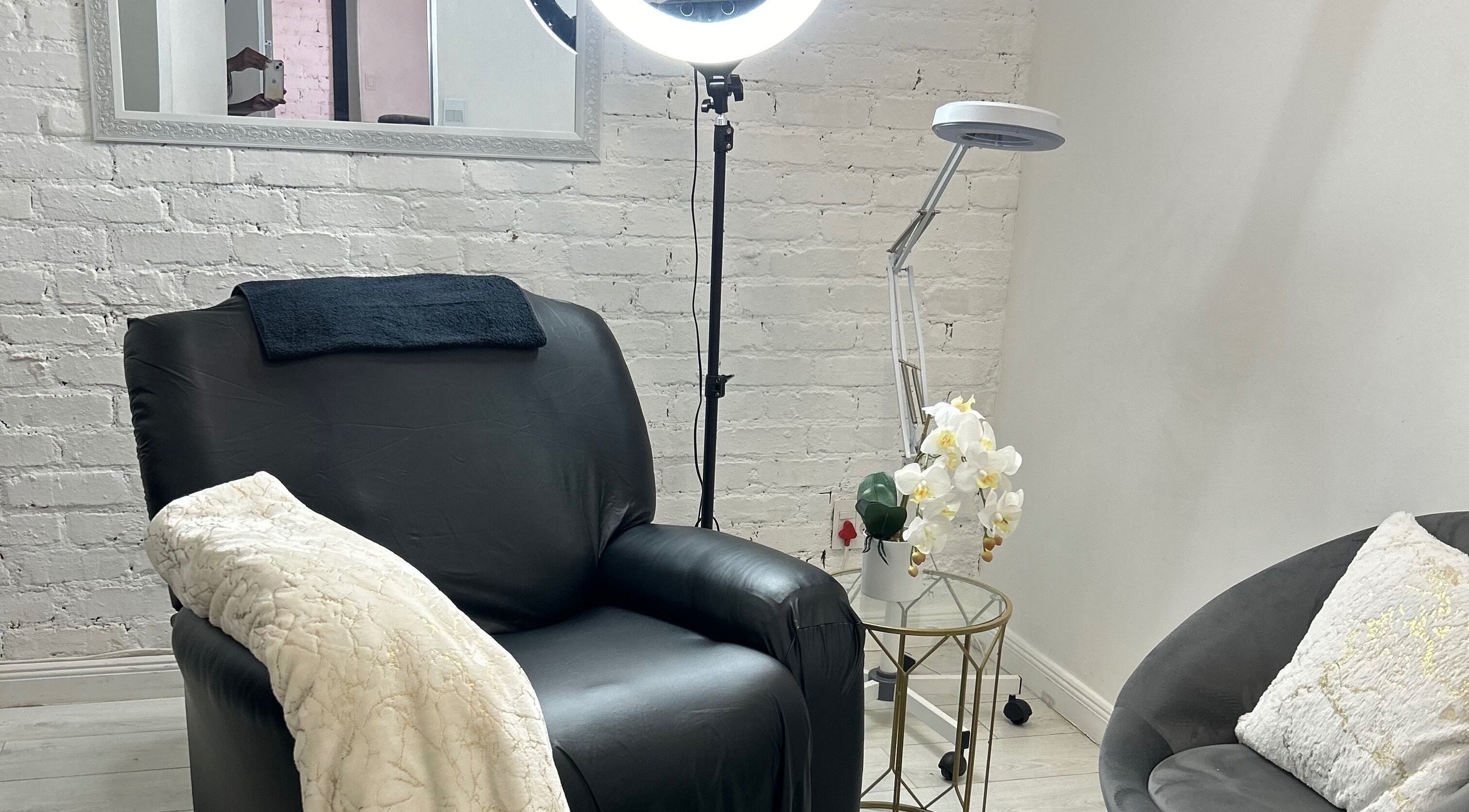 Relaxing seating area at Shugarlashpro | Central Square, Sandton, Gauteng, ZA, featuring cozy decor and a light.