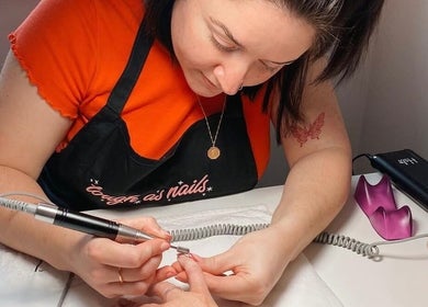 Nail technician at Soph Does Nails, Yate, England, GB expertly manicuring a client's nail.
