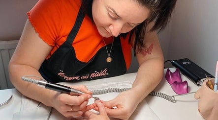 Nail technician at Soph Does Nails, Yate, England, GB expertly manicuring a client's nail.