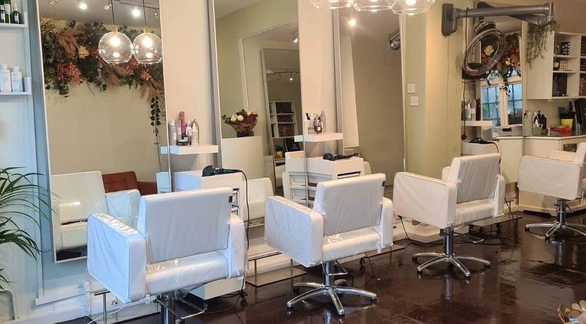Bright interior of Hair Salon Daniella in Dublin, County Dublin, IE with modern white styling chairs and mirrors.