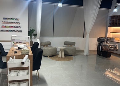Modern salon interior at Fofo Beauty, مسقط, محافظة مسقط, OM with sleek chairs and nail polish display.