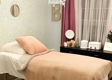 Cozy treatment room at The OG Brazilianaire Studio, Spanish Fork, Utah, US with pink accents and modern decor.
