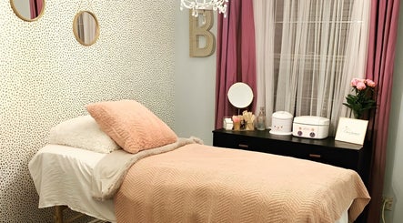 Cozy treatment room at The OG Brazilianaire Studio, Spanish Fork, Utah, US with pink accents and modern decor.