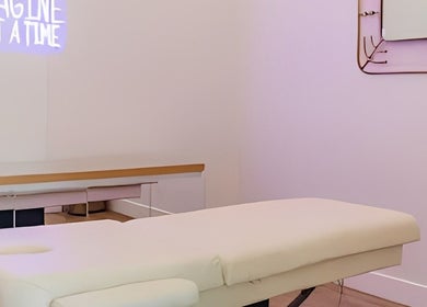 Relaxing treatment room at The OG Brazilianaire Studio in Spanish Fork, Utah, US with massage table and decor.