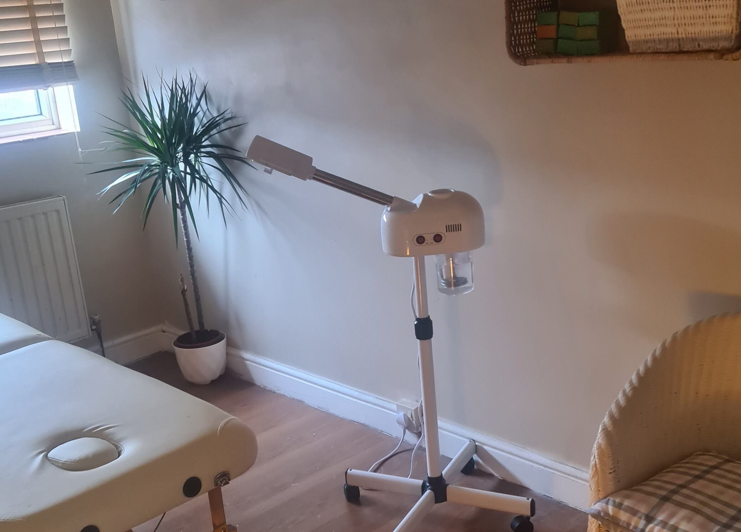 Relaxing treatment room with massage table and steamer at Sadia, Slough, England, GB.