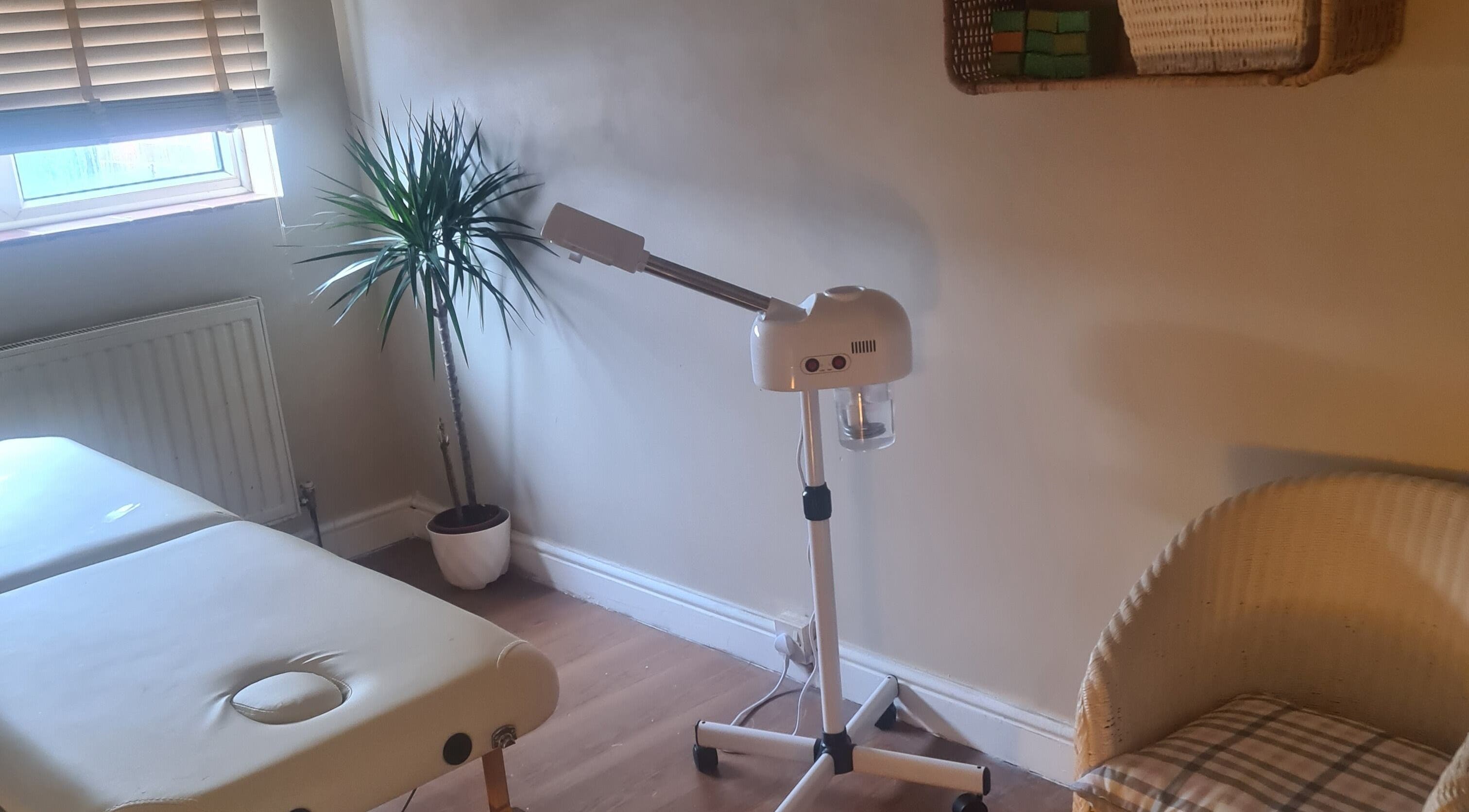 Relaxing treatment room with massage table and steamer at Sadia, Slough, England, GB.