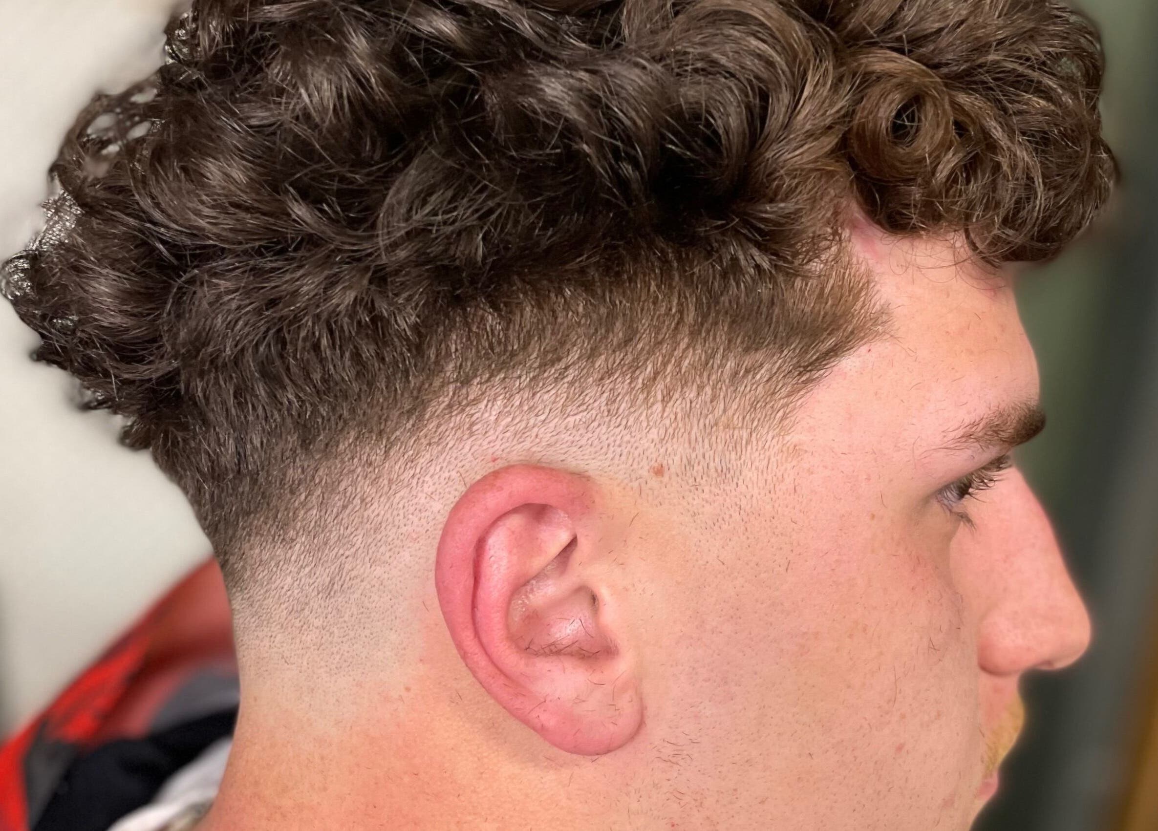 Close-up of a trendy curly fade haircut at EFRO CUTS, Melbourne, Victoria, AU.