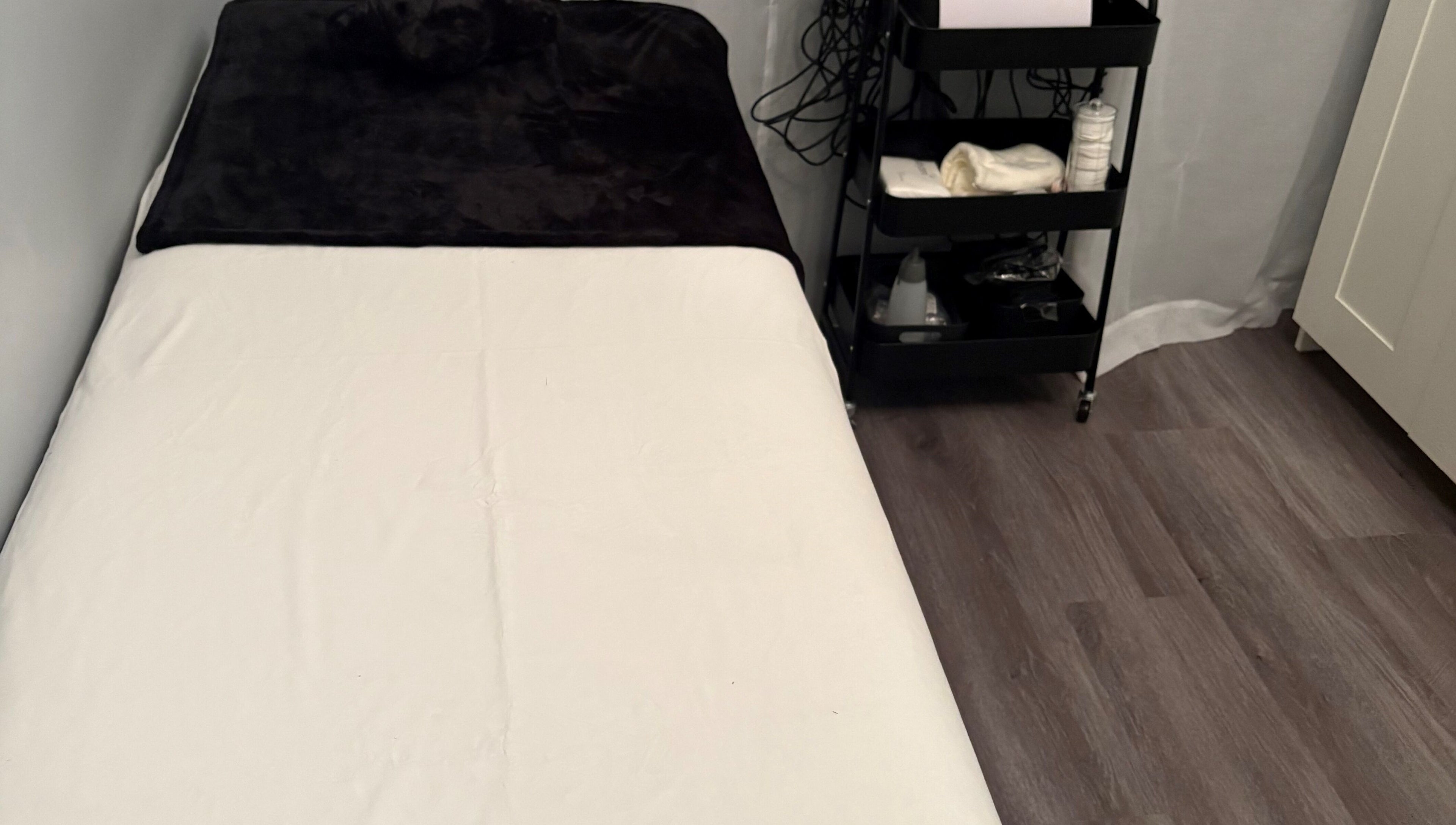 Cozy treatment room at Sculpte Society, Warnbro, Western Australia, AU. Features massage bed and wellness essentials.