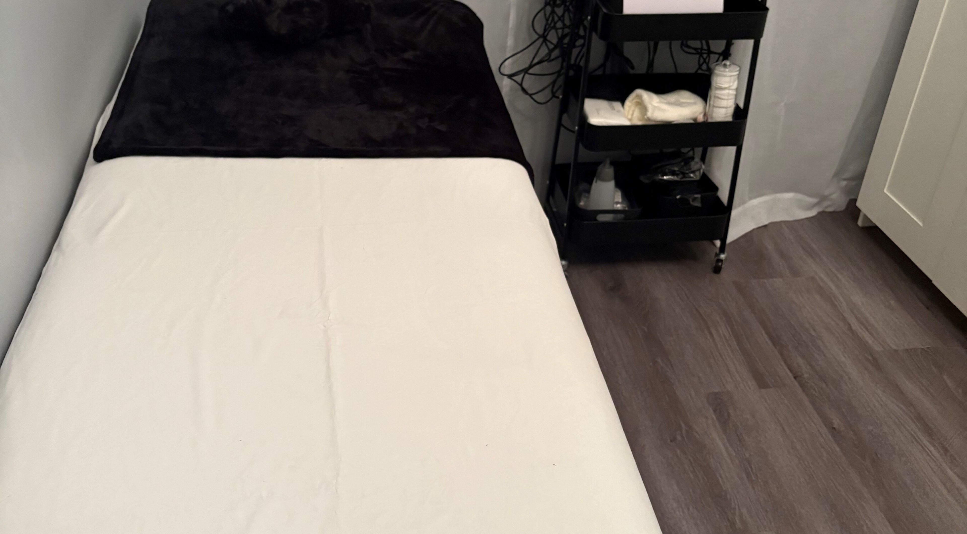 Cozy treatment room at Sculpte Society, Warnbro, Western Australia, AU. Features massage bed and wellness essentials.