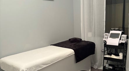 Cozy treatment room at Sculpte Society, Warnbro, Western Australia, AU with bed and modern equipment.