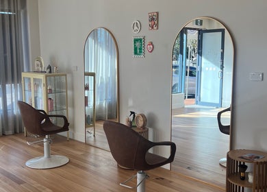 Chic styling area at Spiritual Soul Hair Co - Gerringong, featuring elegant mirrors and comfortable chairs.