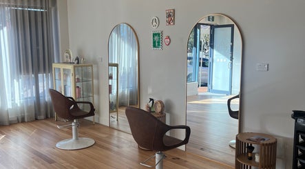 Chic styling area at Spiritual Soul Hair Co - Gerringong, featuring elegant mirrors and comfortable chairs.