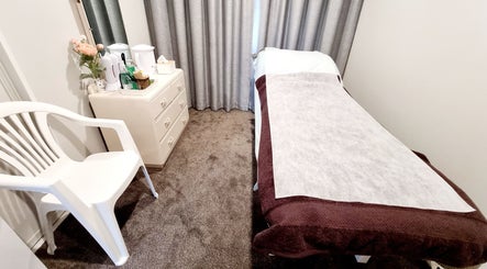 Tranquil treatment room at JDBeauty, Pegasus, Canterbury Region, NZ, featuring a massage bed and essentials.