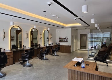 Stylish interior of The Good Man salon in Dubai, Dubai, AE, featuring modern barber chairs and sleek decor.