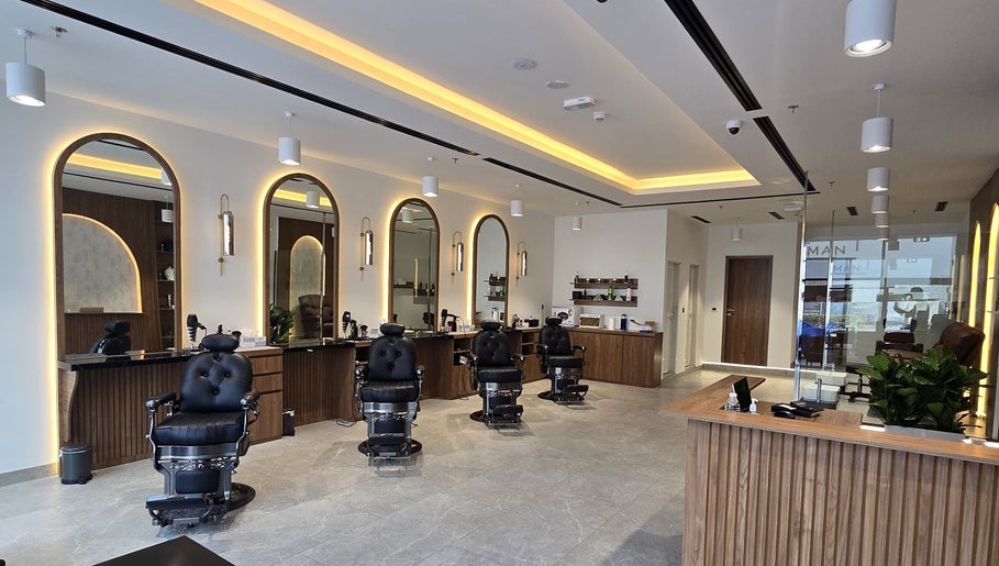 Elegant barber chairs and mirrors at The Good Man in Dubai, Dubai, AE, showcasing modern wellness.