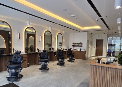 Elegant barber chairs and mirrors at The Good Man in Dubai, Dubai, AE, showcasing modern wellness.