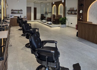 Chic barber chairs at The Good Man, Dubai, AE, offering luxurious grooming services.