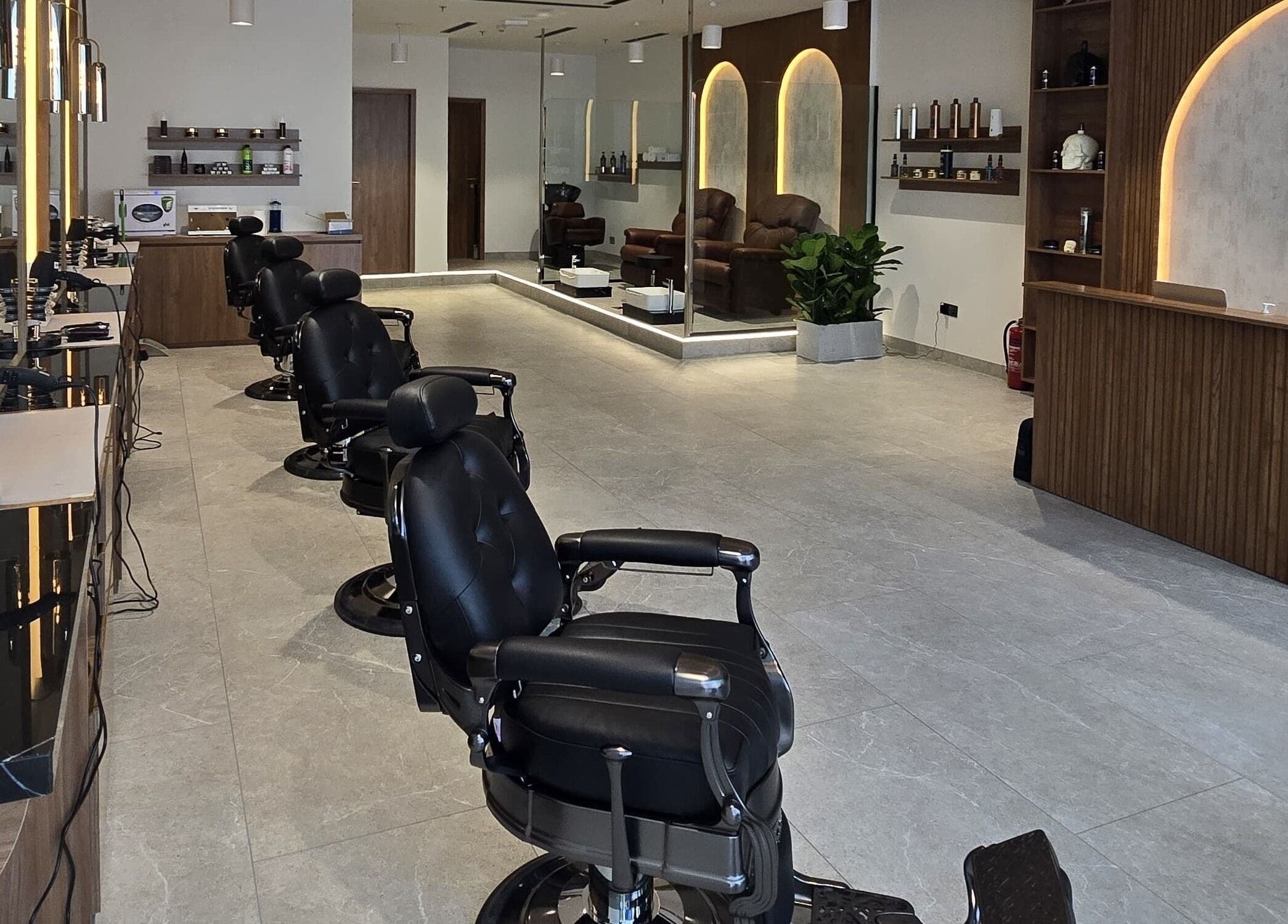 Sleek interior of The Good Man salon in Dubai, Dubai, AE with modern styling chairs and elegant decor.
