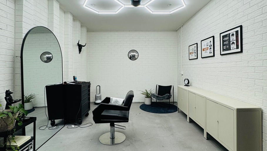 Modern salon interior at Ash Bang, Melbourne, Victoria, AU showcasing sleek chairs and minimal decor.