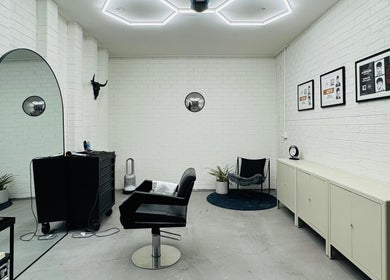 Modern salon interior at Ash Bang, Melbourne, Victoria, AU showcasing sleek chairs and minimal decor.