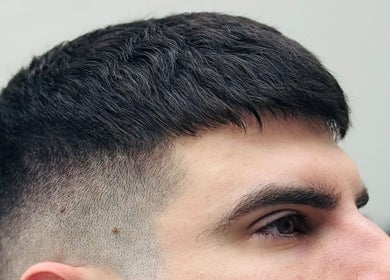 Close-up of a stylish fade haircut at Ash Bang, Melbourne, Victoria, AU, highlighting sharp barber skills.