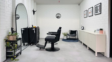 Modern salon interior at Ash Bang, Melbourne, Victoria, AU with elegant decor and styling chair.