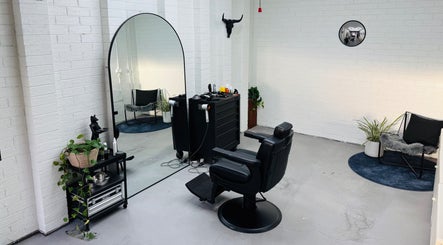 Stylish salon chair and mirror at Ash Bang, Melbourne, Victoria, AU with modern decor and greenery.