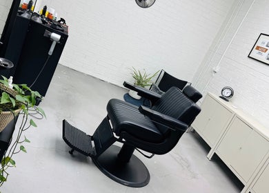 Modern barber chair at Ash Bang, Melbourne, Victoria, AU with stylish decor and sleek equipment.